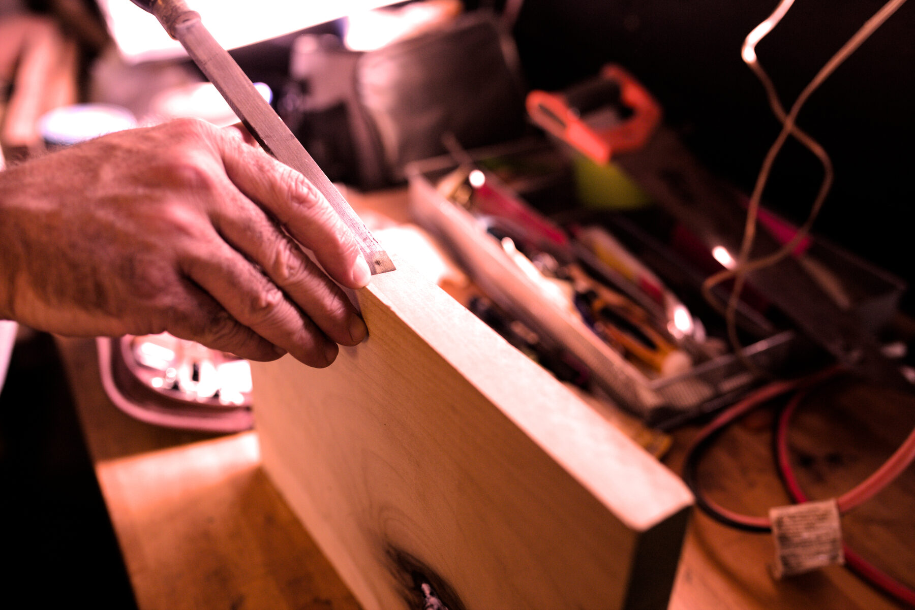 The maker shaping hardwood at the bench in the Niagara workshop